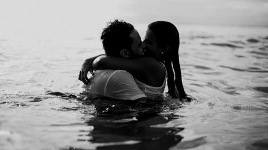 Romantic couple embracing in water, evoking intimacy and connection for adult lifestyle products.