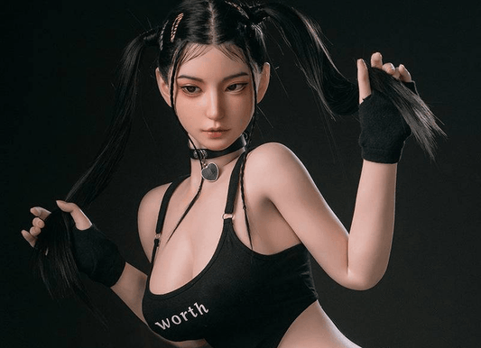 Realistic adult doll with black pigtails, choker, and 'worth' top, styled for intimate play